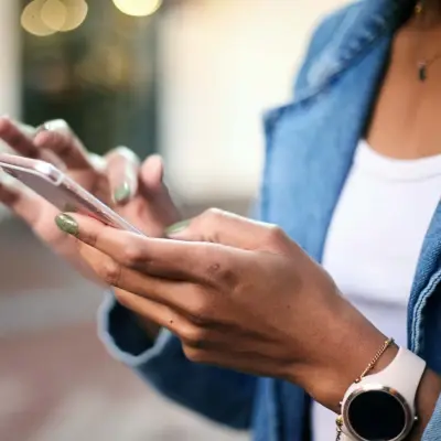 Functional Testing Two An independent tester using a smartphone to evaluate software behavior on actual devices.