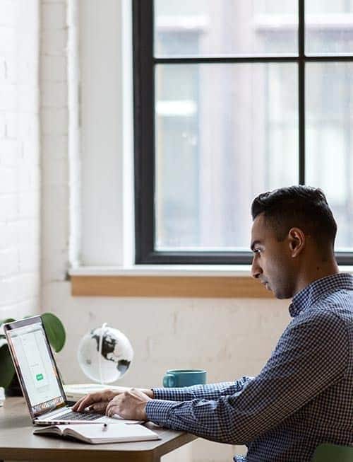 Person looking at screen in a home office.